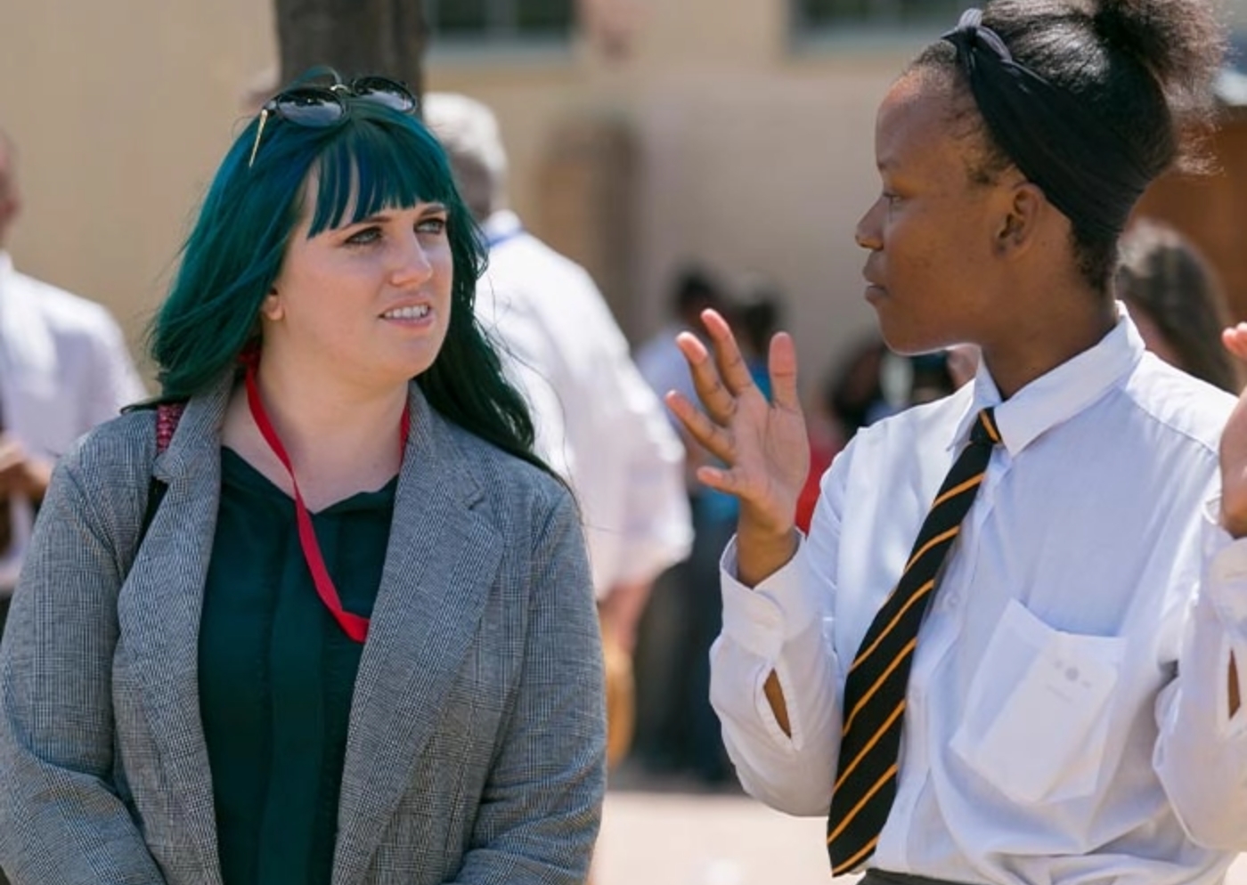 woman in shite button down shirt smiling