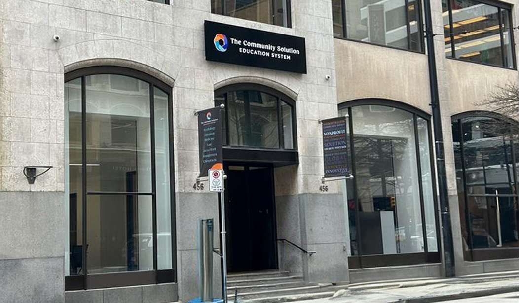 red haired woman holding son with graduation cap on